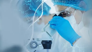 Scientist looking into a microscope
